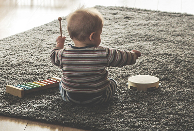 A child playing with musical instruments